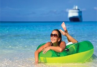 An woman wearing sunglasses relaxes on a floating tube in the shallow water at a clear water beach