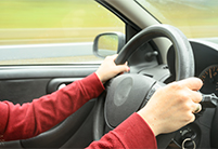 Driver holding steering wheel